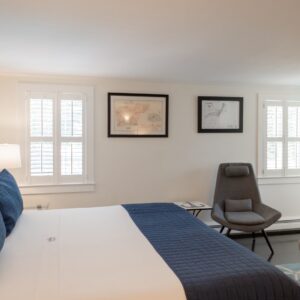 White bedroom with blue accents.
